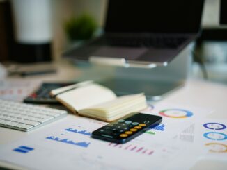 a remote control sitting on top of a table next to a book